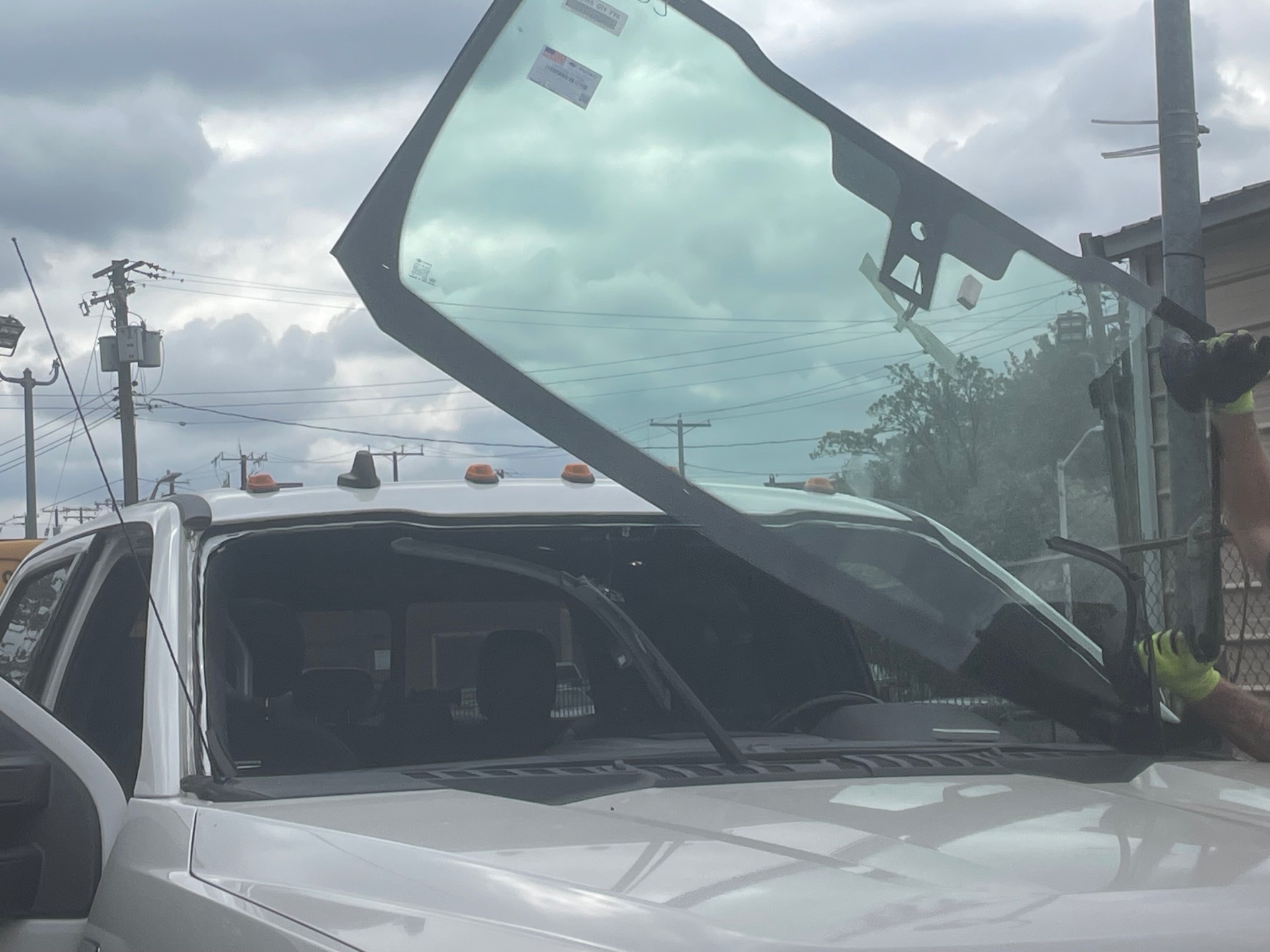 Windshield being lifted into place by MCA technician